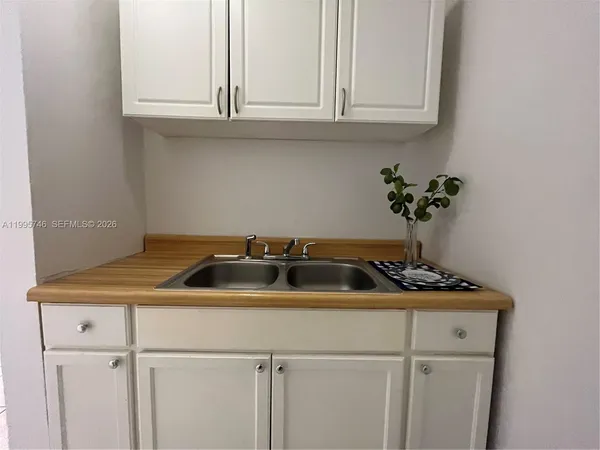 a kitchen with a sink and cabinets