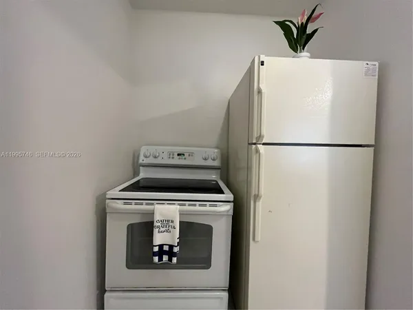 a white refrigerator freezer sitting inside of a kitchen