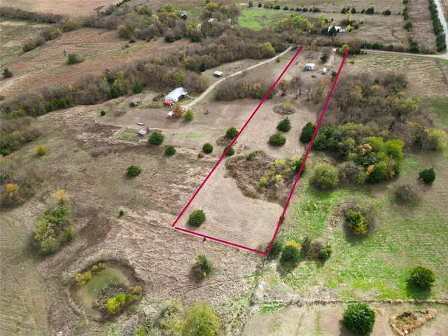an aerial view of a house with a yard and plants