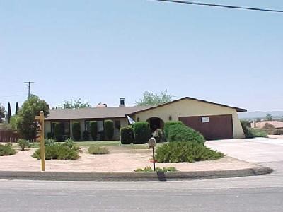 19203 Seneca Road Apple Valley, CA 92307 - Photo 1 of 1 a house with a yard and a car parked in front of it