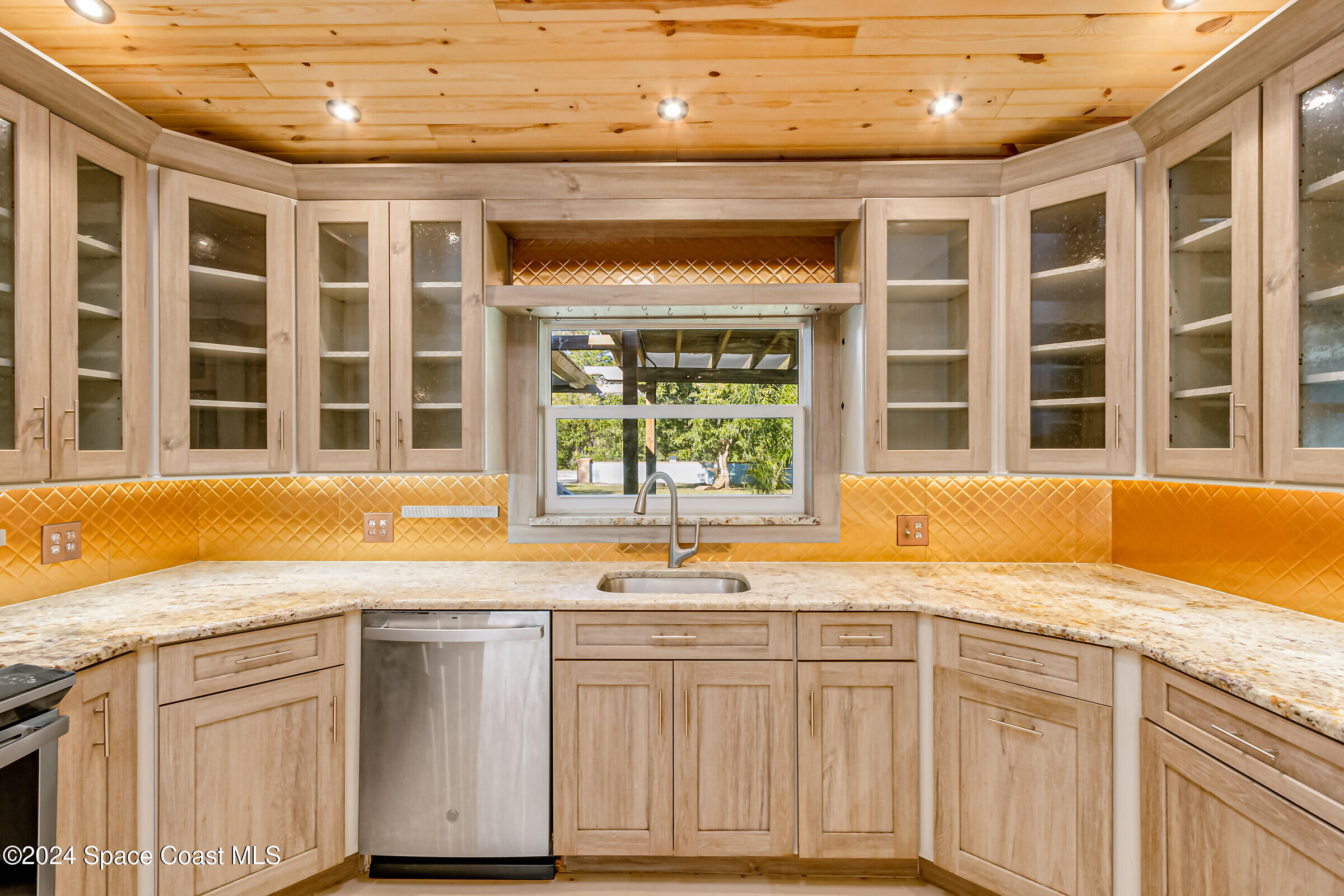 1235 Pine Island Road Merritt Island, FL 32953 - Photo 12 of 45 a view of a kitchen with granite countertop a sink and a white wooden cabinets
