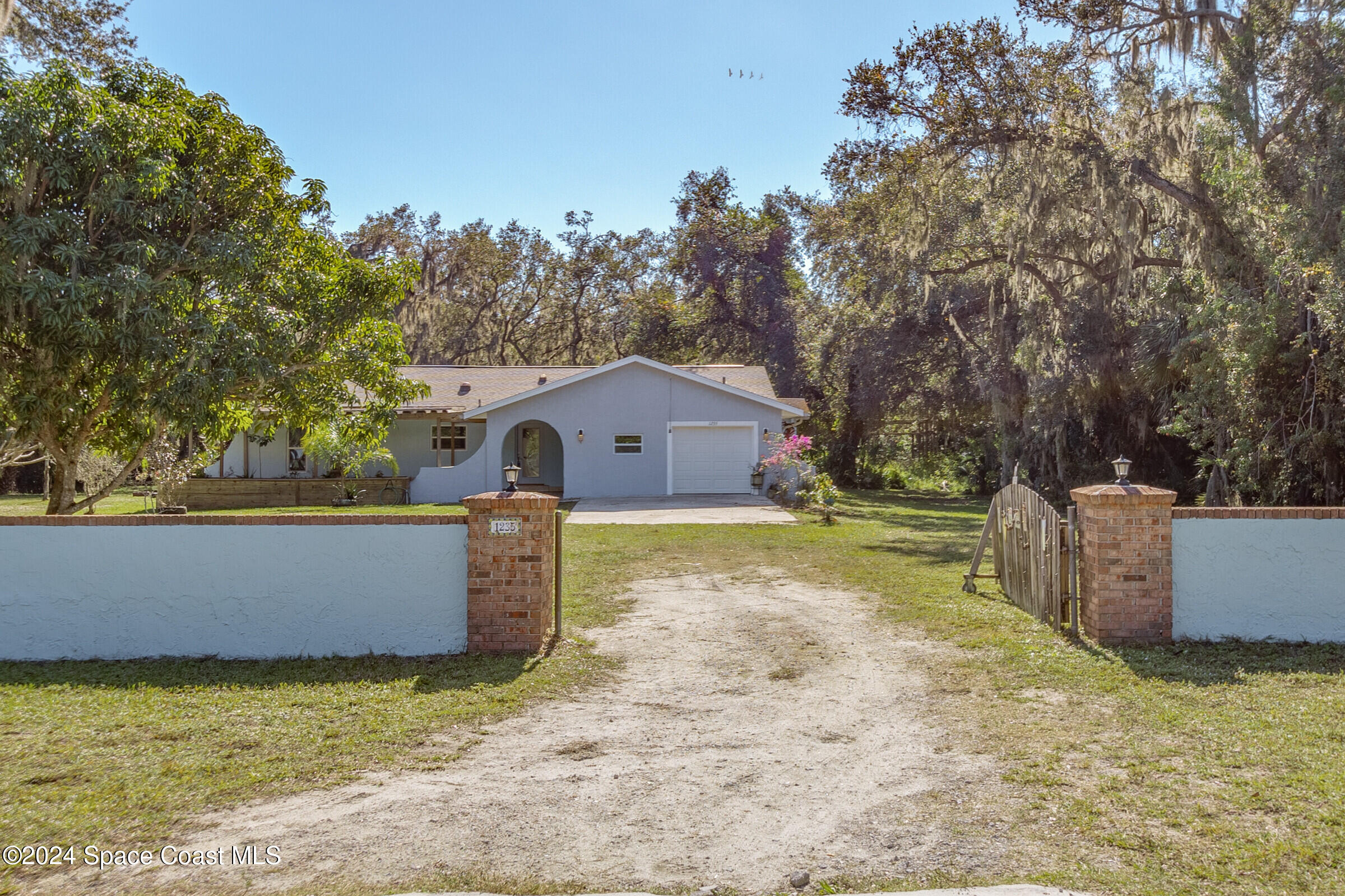 1235 Pine Island Road Merritt Island, FL 32953 - Photo 2 of 45 a view of a house with a yard and tree