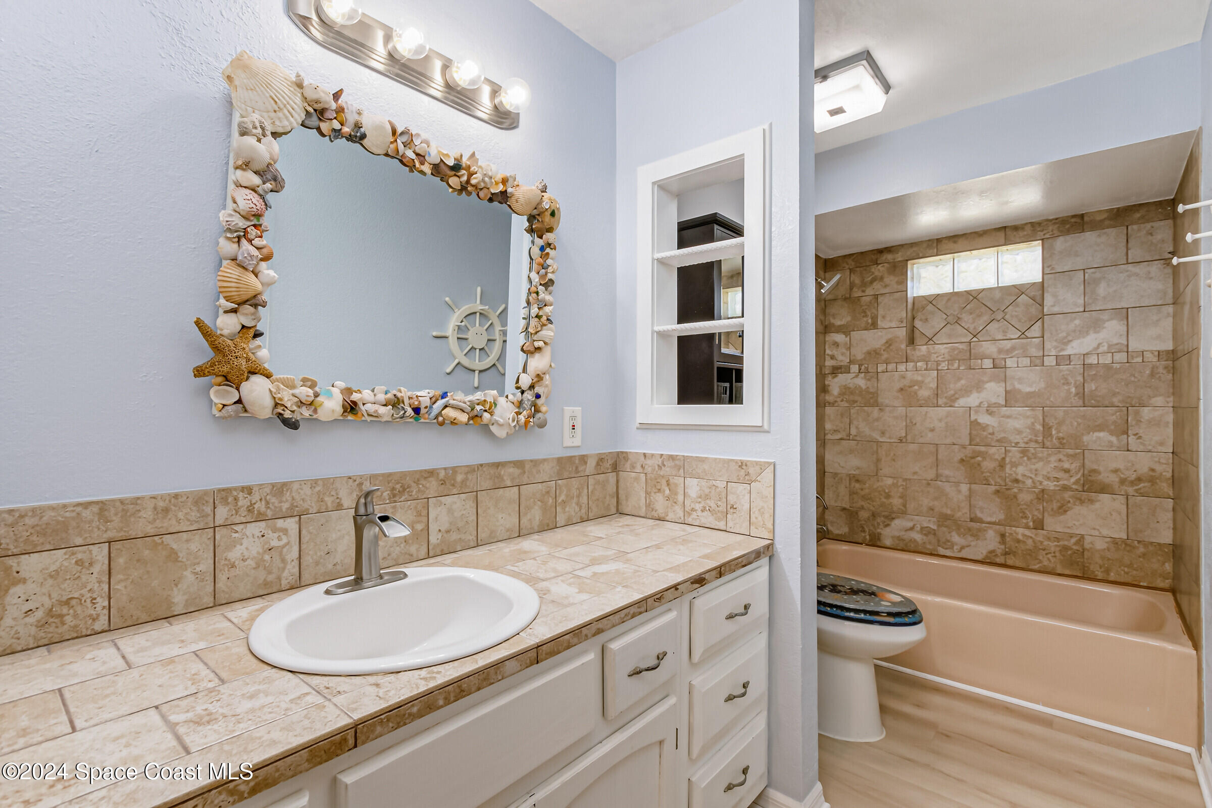 1235 Pine Island Road Merritt Island, FL 32953 - Photo 21 of 45 a bathroom with a granite countertop sink mirror vanity and toilet