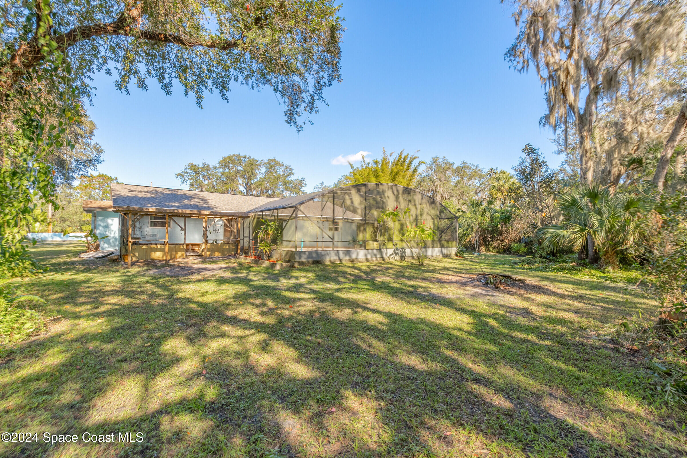 1235 Pine Island Road Merritt Island, FL 32953 - Photo 29 of 45 a view of a big yard with a large tree