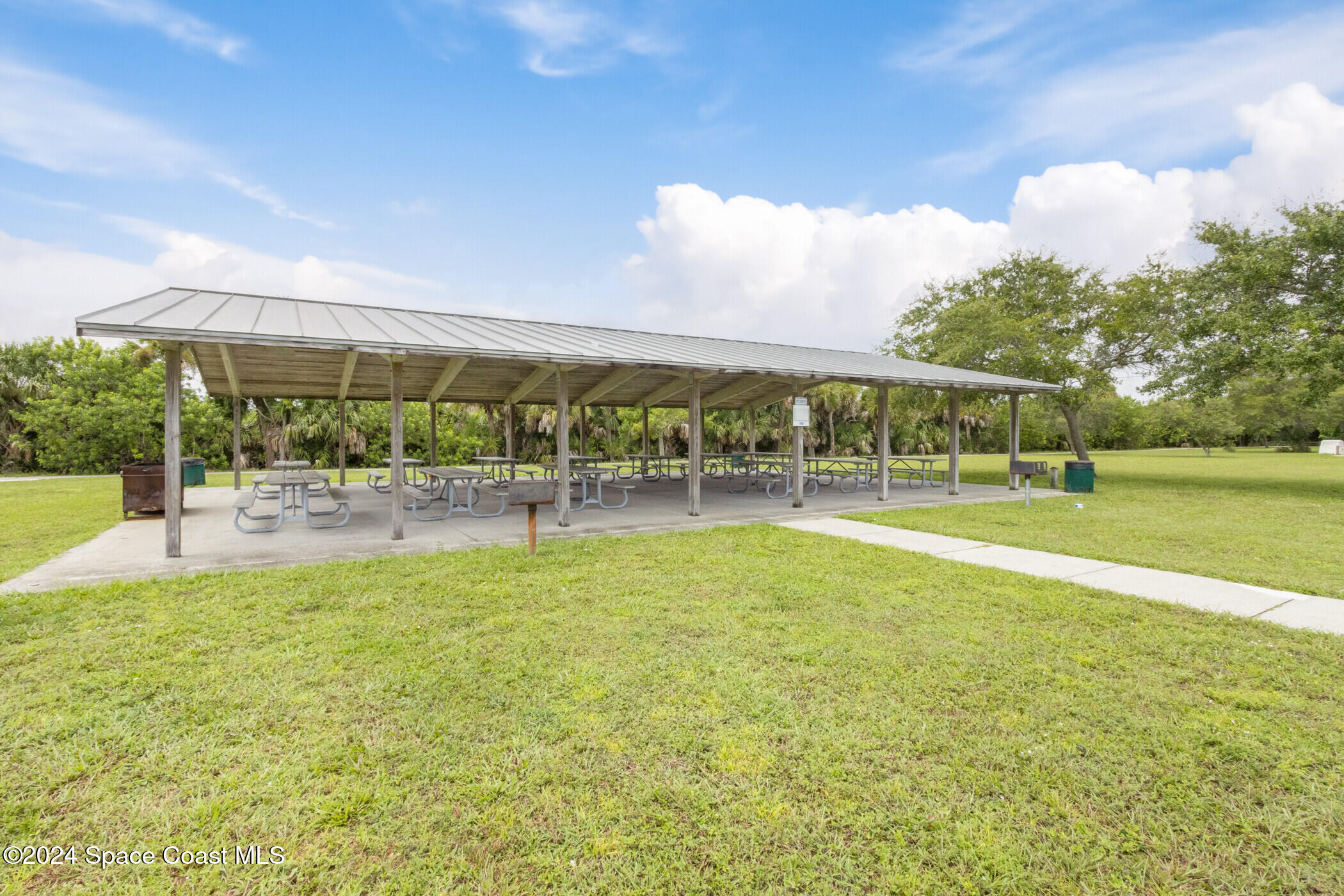1235 Pine Island Road Merritt Island, FL 32953 - Photo 33 of 45 a view of a swimming pool with an outdoor seating and a yard
