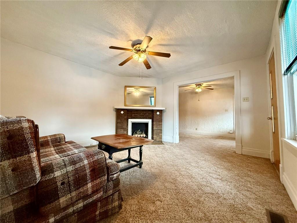 1126 Penn Avenue Vandergrift, PA 15690 - Photo 12 of 24 a view of a livingroom with furniture and a fireplace