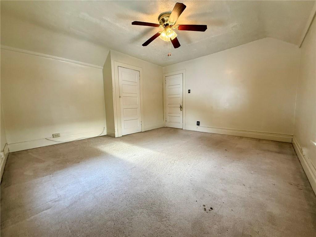 1126 Penn Avenue Vandergrift, PA 15690 - Photo 19 of 24 an empty room with chandelier fan and windows