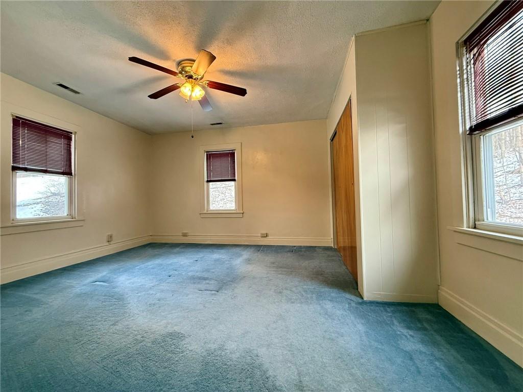 1126 Penn Avenue Vandergrift, PA 15690 - Photo 20 of 24 an empty room with windows and fan