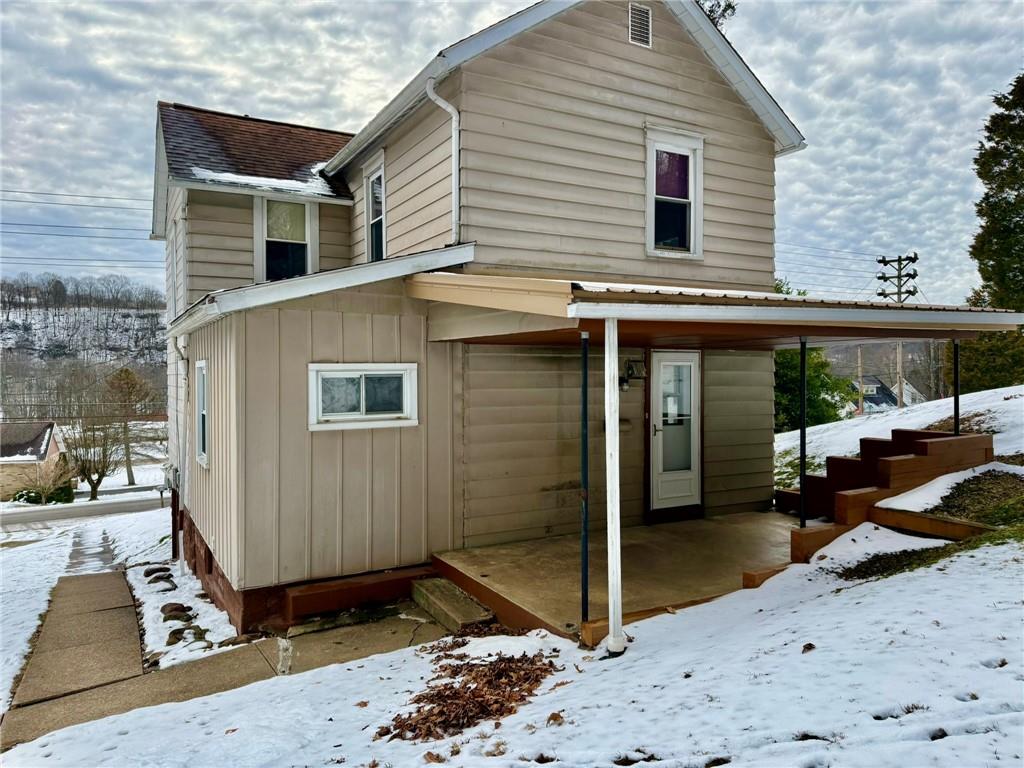 1126 Penn Avenue Vandergrift, PA 15690 - Photo 3 of 24 a view of a house with a lounge chairs in patio