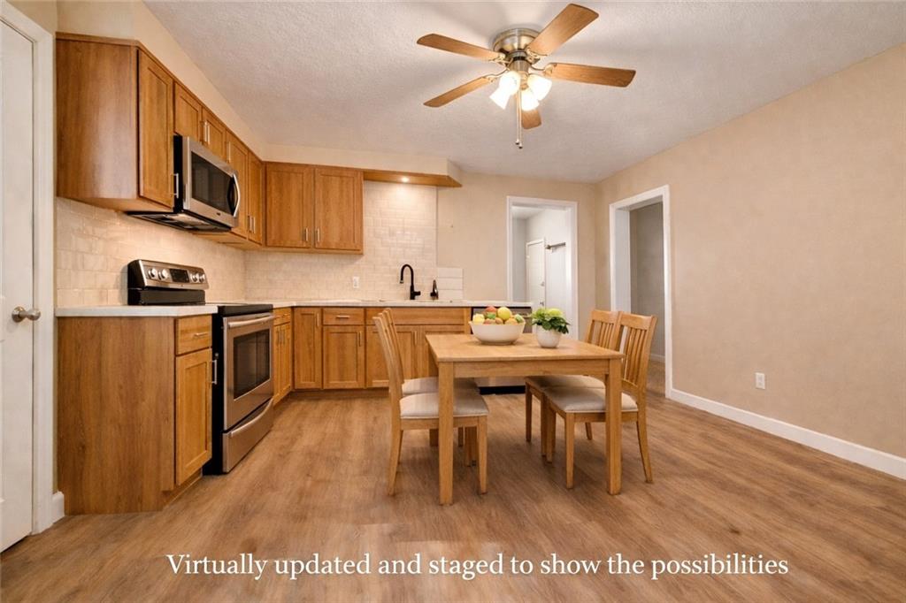 1126 Penn Avenue Vandergrift, PA 15690 - Photo 7 of 24 a large kitchen with a table and chairs