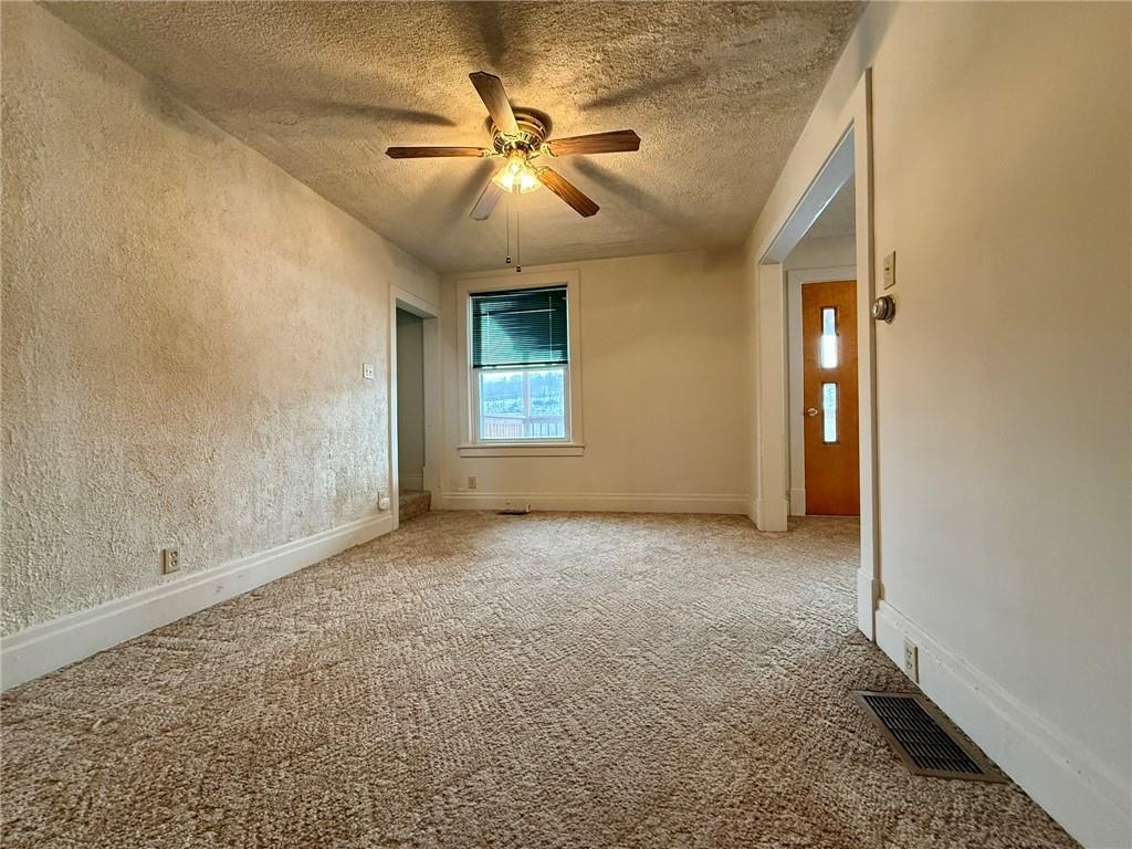 1126 Penn Avenue Vandergrift, PA 15690 - Photo 8 of 24 an empty room with windows and fan