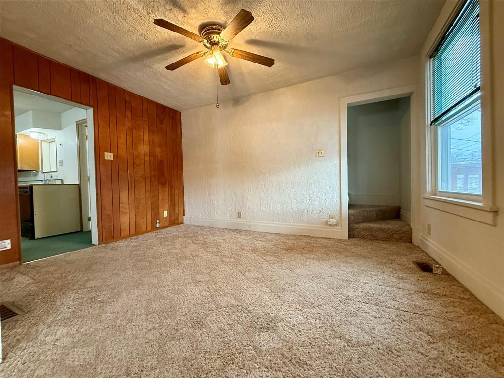 1126 Penn Avenue Vandergrift, PA 15690 - Photo 9 of 24 an empty room with chandelier fan and windows