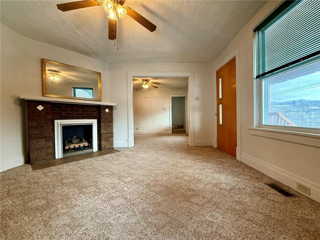 1126 Penn Avenue Vandergrift, PA 15690 - Photo 10 of 24 a view of an empty room with a fireplace and a window