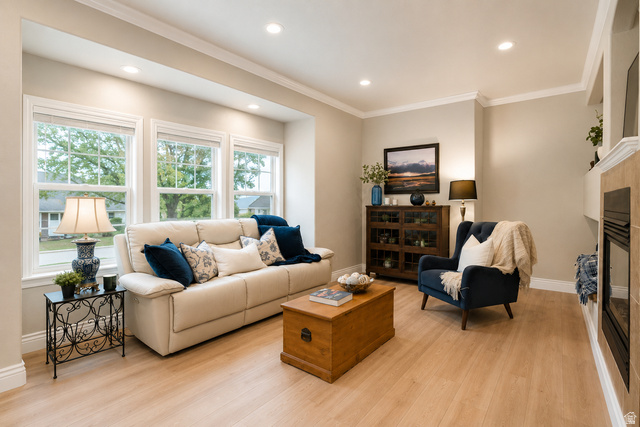 896 Cres Drive South Mapleton, UT 84664 - Photo 4 of 32 Living area featuring three large windows, recessed lighting, wood-finish flooring, a tiled fireplace, and built-in shelving