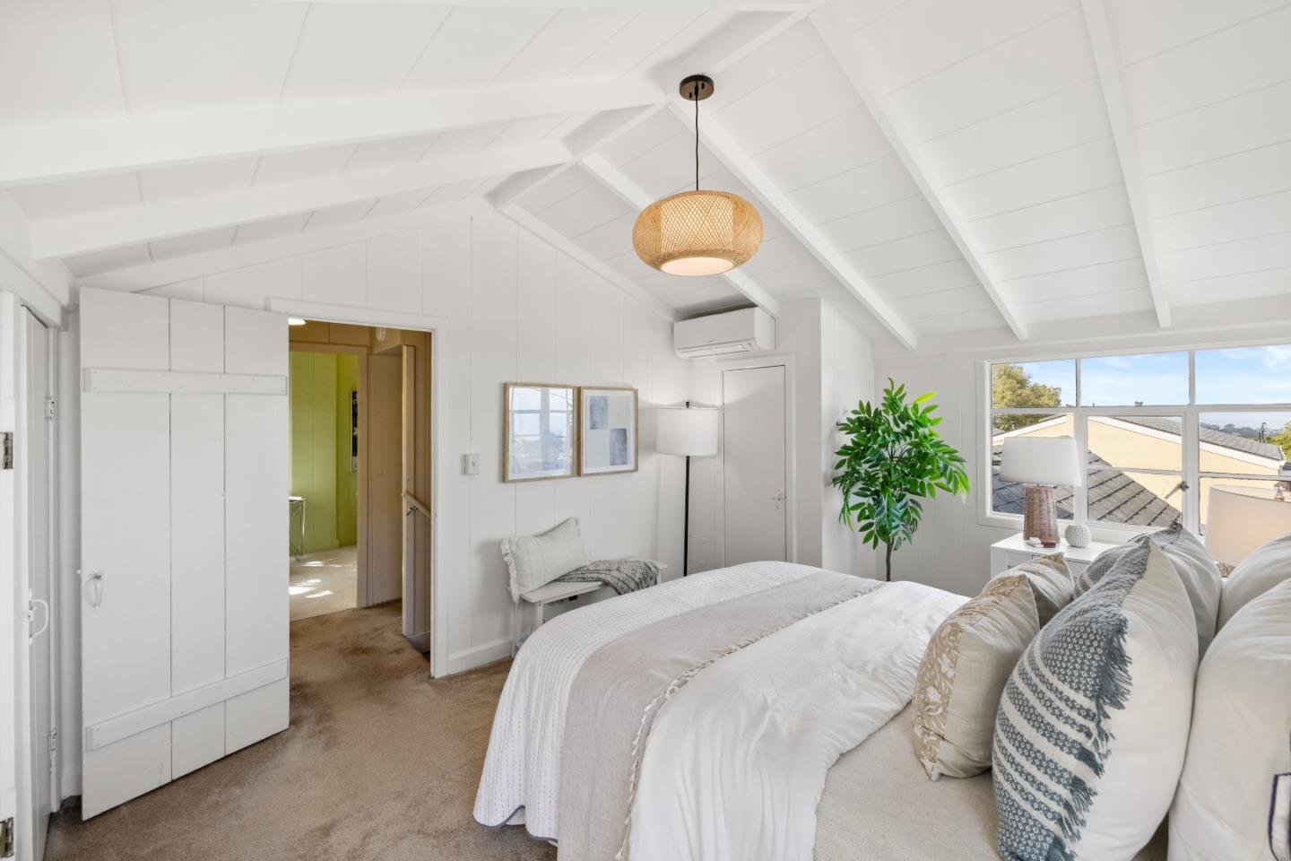 705 Grace Street Monterey, CA 93940 - Photo 16 of 28 a spacious bedroom with a bed and a chandelier
