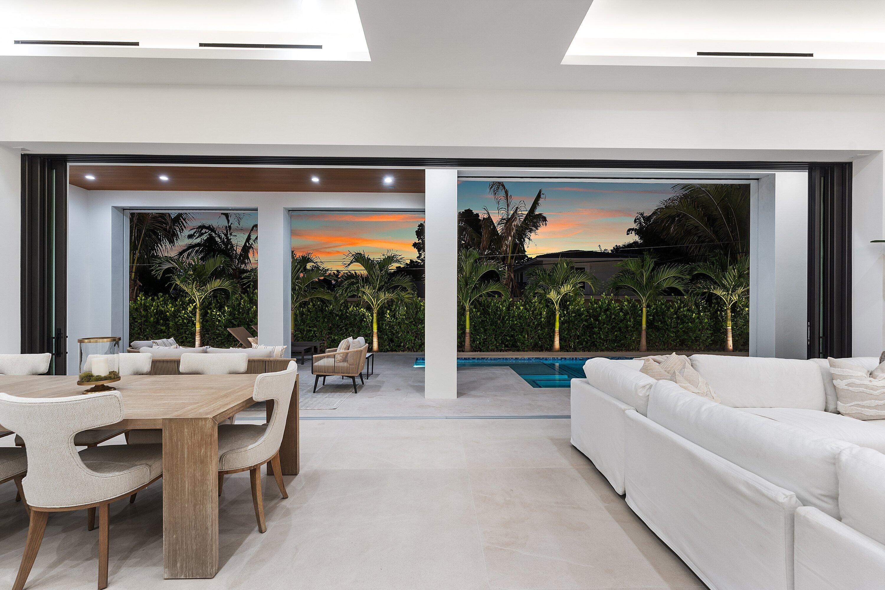 2609 Northeast 27th Way Fort Lauderdale, FL 33306 - Photo 46 of 53 a living room with patio furniture and a floor to ceiling window