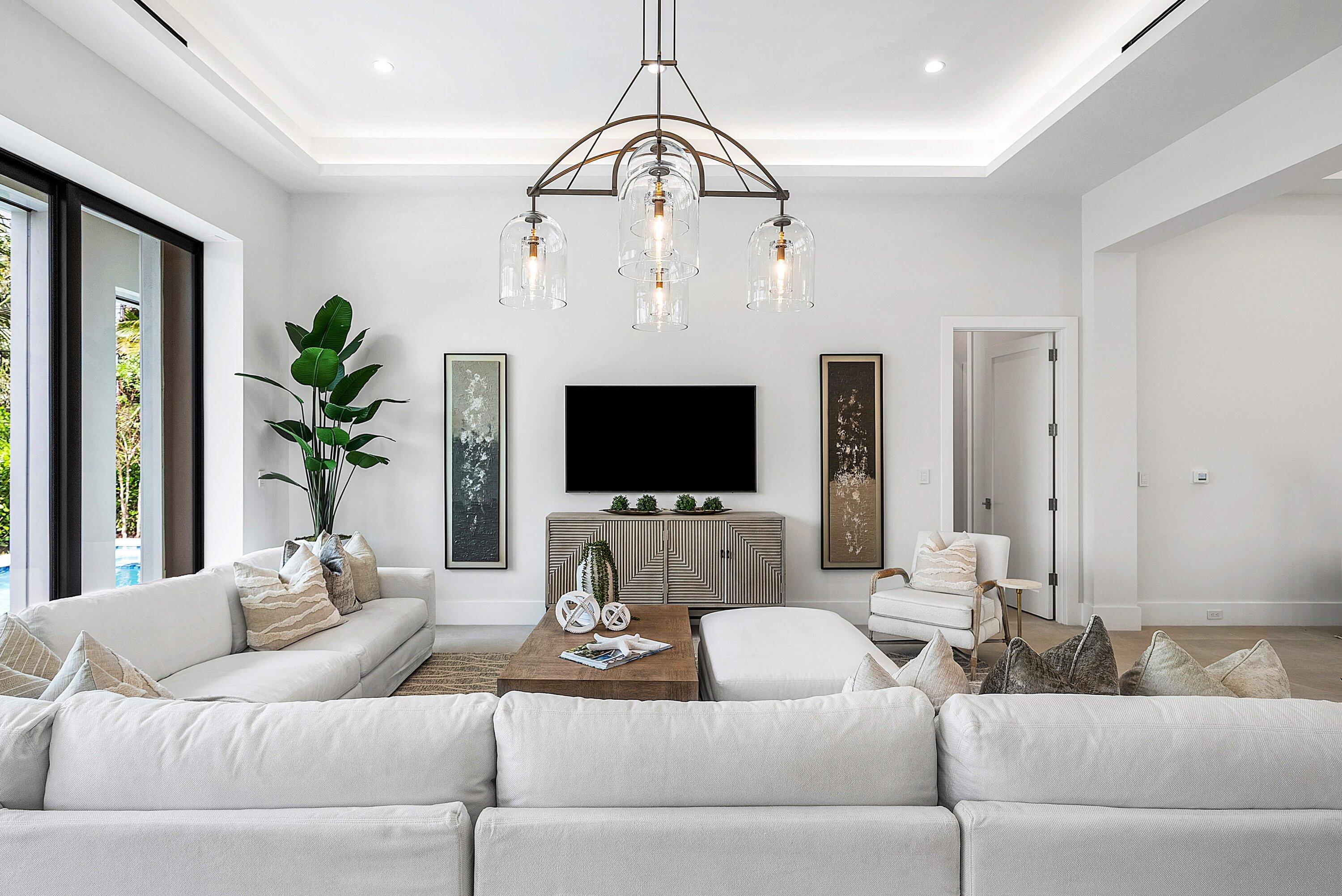 2609 Northeast 27th Way Fort Lauderdale, FL 33306 - Photo 7 of 53 a living room with furniture a flat screen tv and a potted plant