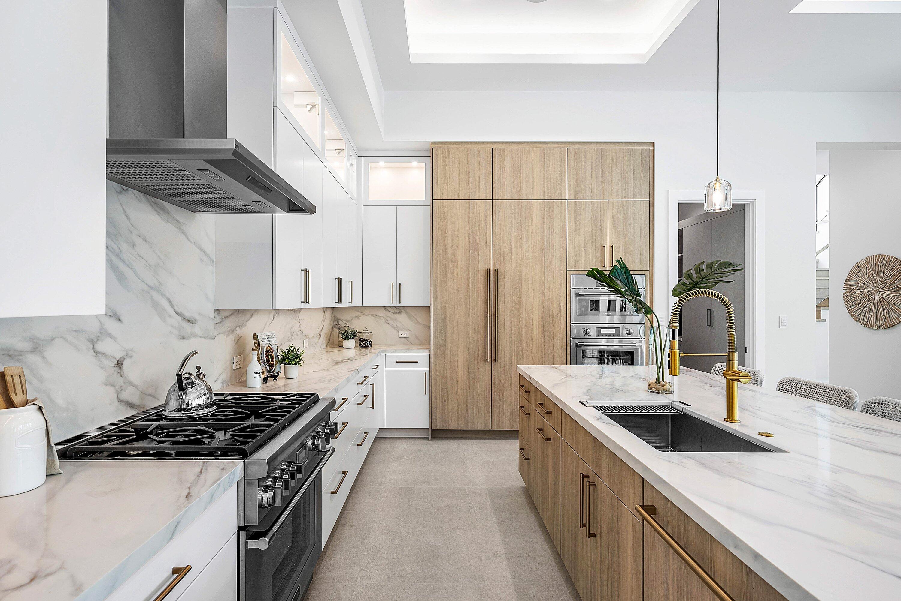 2609 Northeast 27th Way Fort Lauderdale, FL 33306 - Photo 9 of 53 a kitchen with stainless steel appliances granite countertop a sink stove and refrigerator