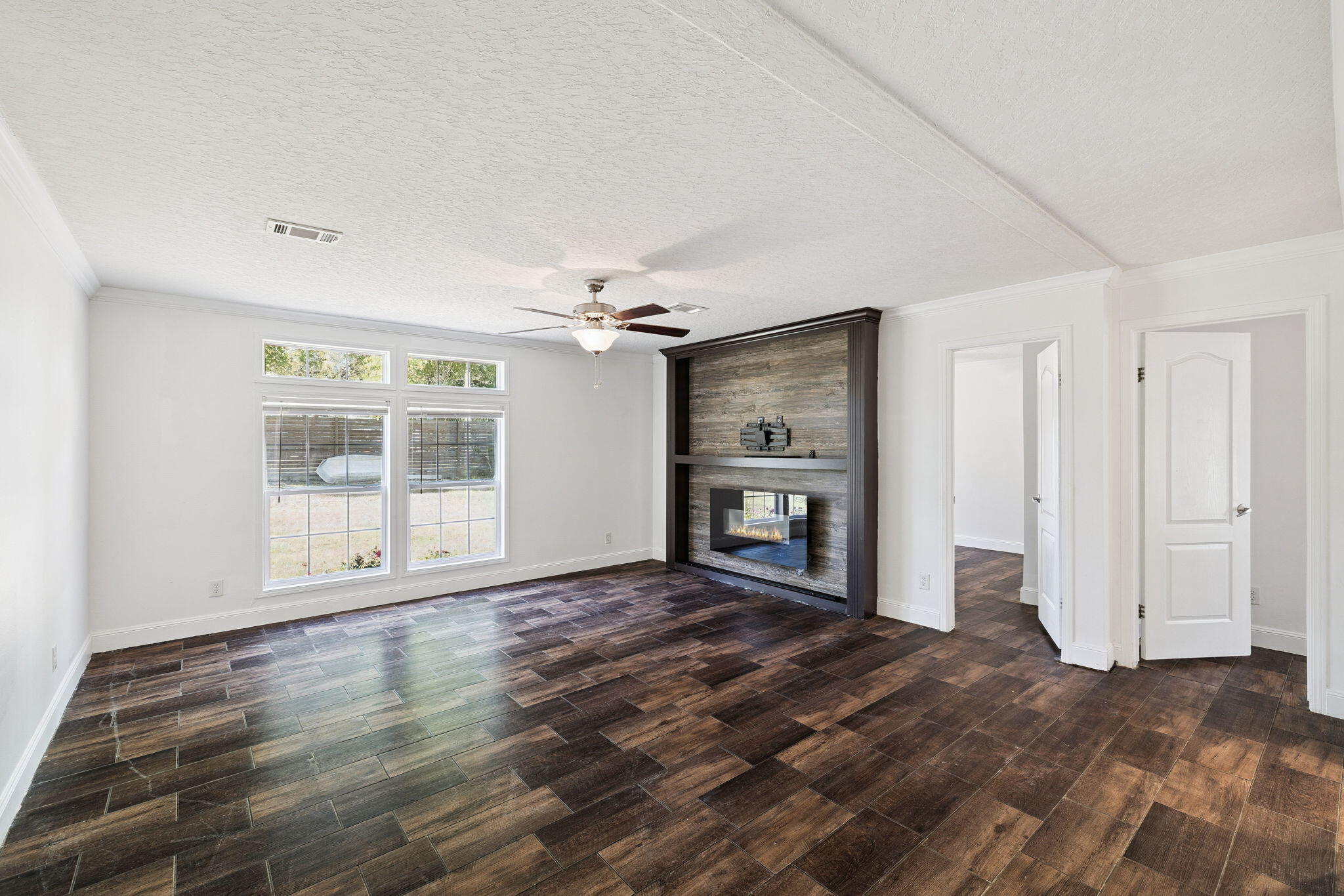 748 Phillips Drive Freeport, FL 32439 - Photo 13 of 32 a view of empty room with wooden floor and fan