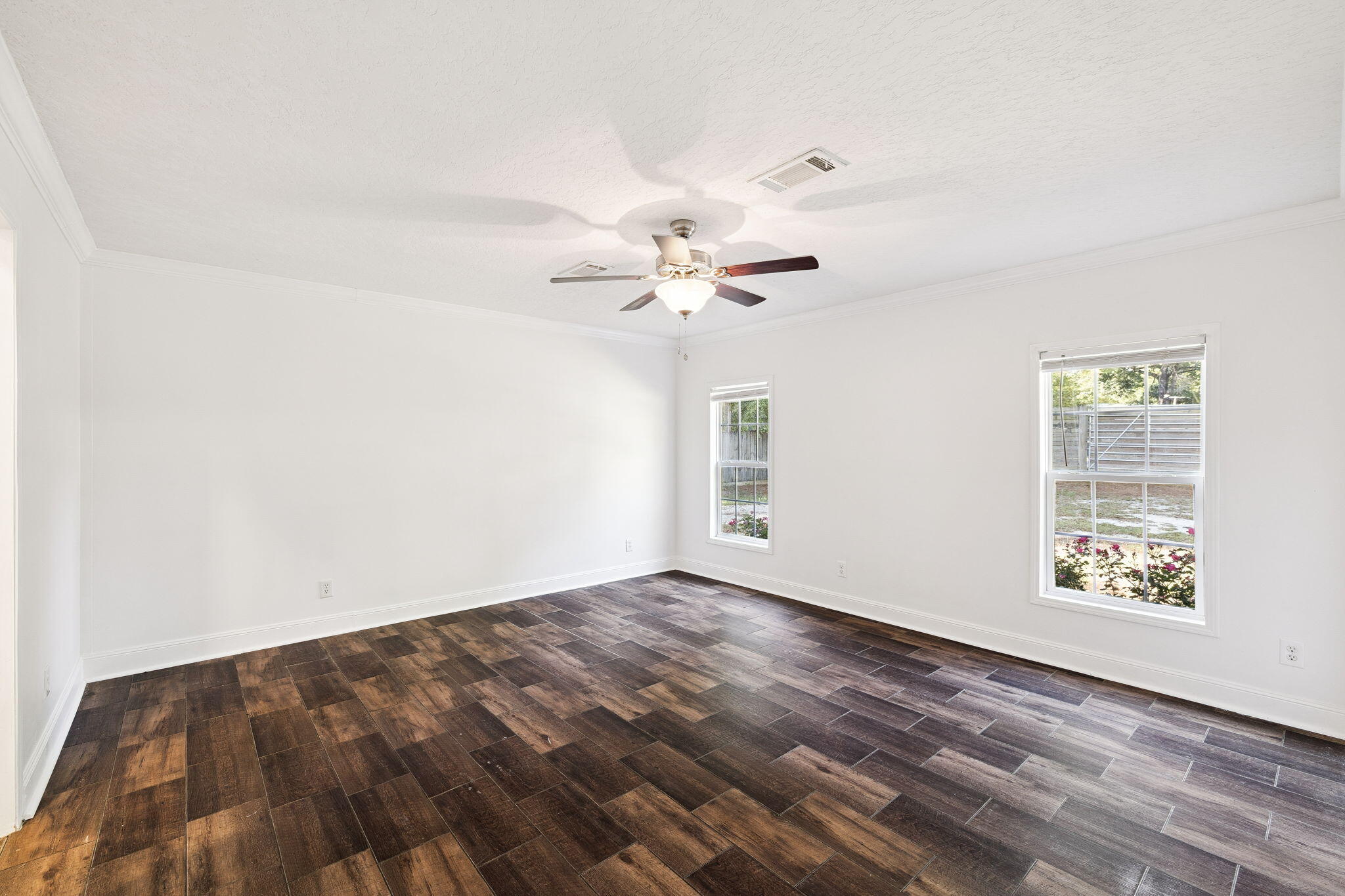 748 Phillips Drive Freeport, FL 32439 - Photo 14 of 32 wooden floor in an empty room with a window