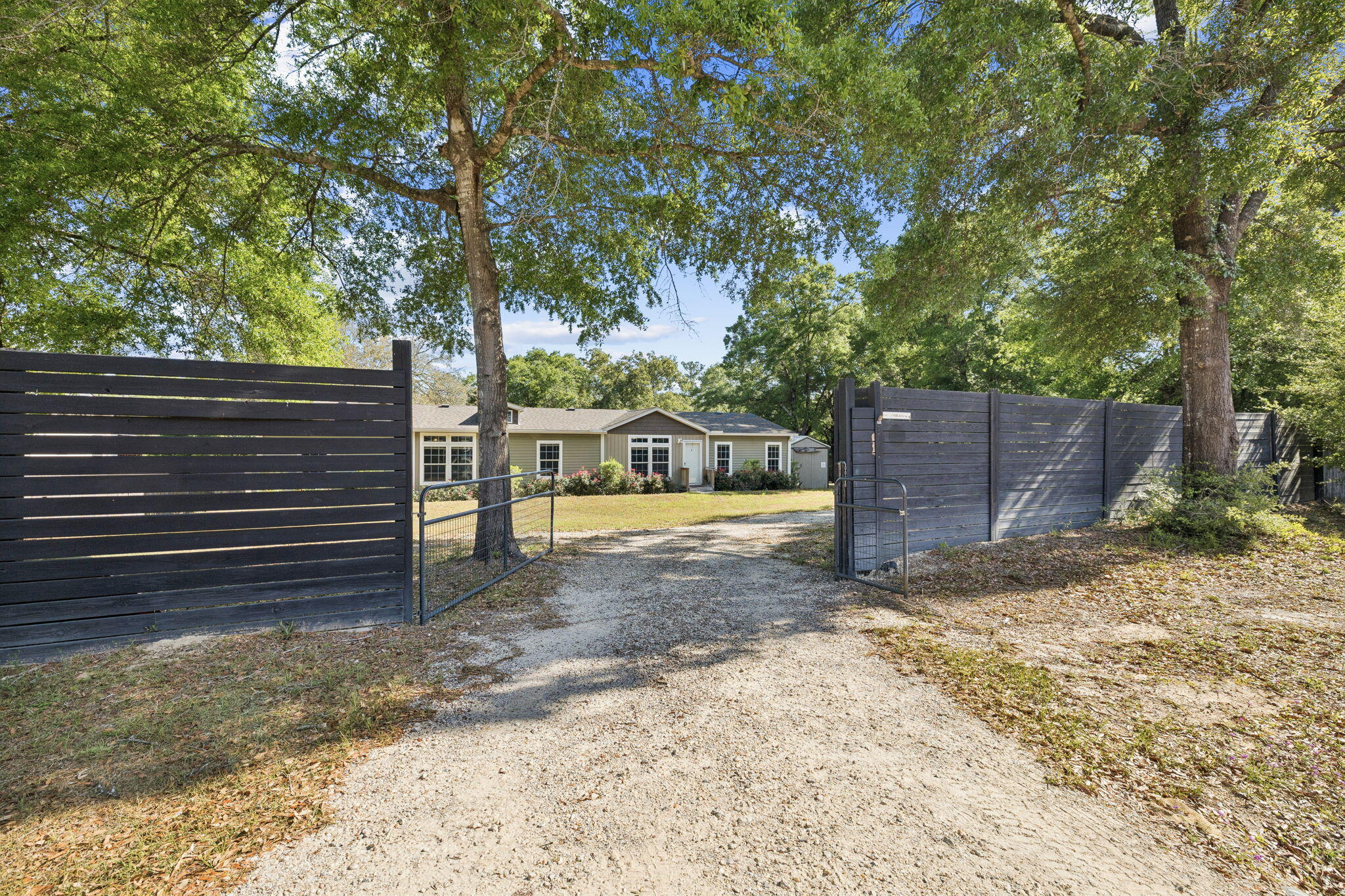 748 Phillips Drive Freeport, FL 32439 - Photo 2 of 32 a view of a yard with wooden fence