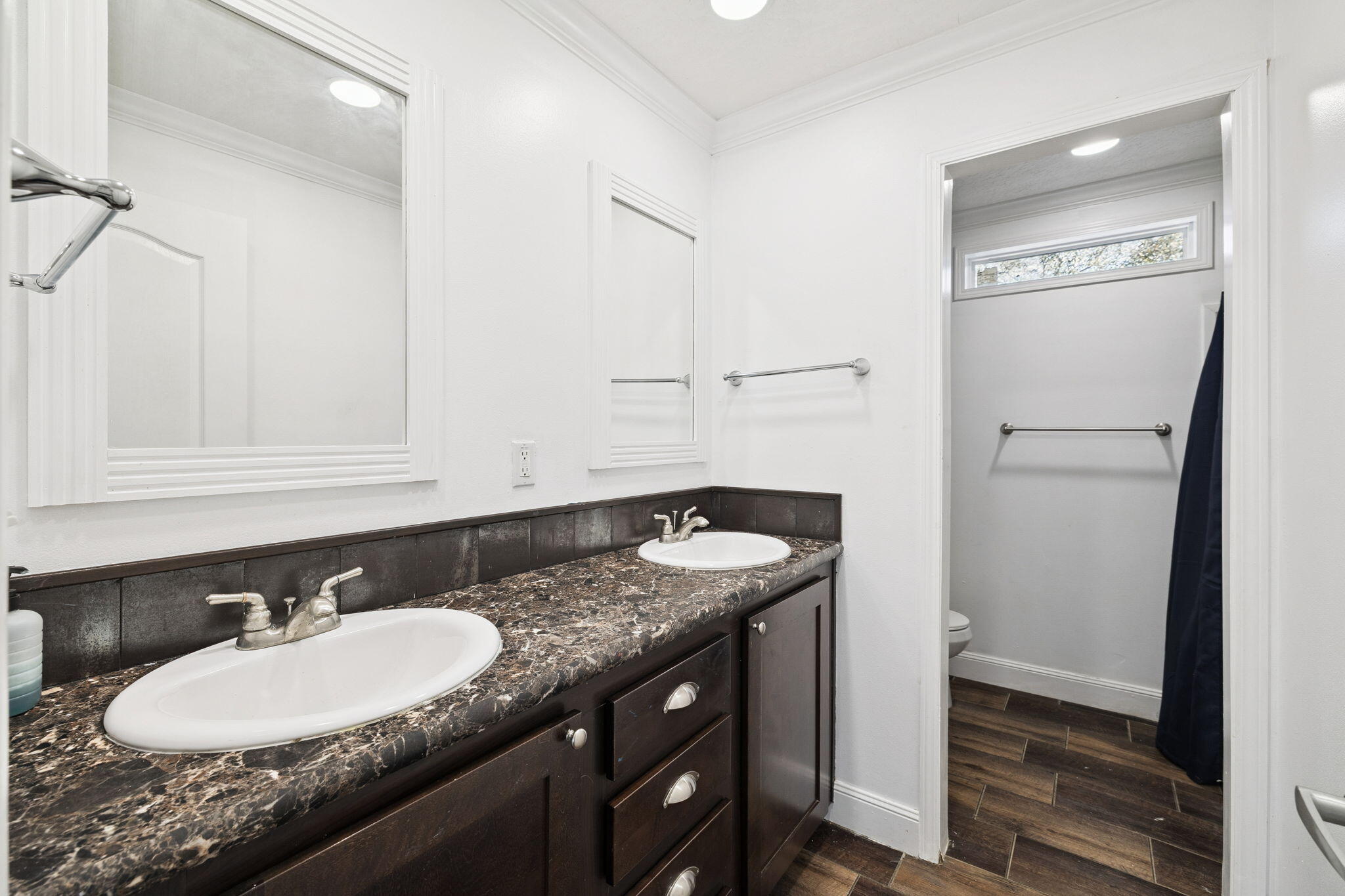 748 Phillips Drive Freeport, FL 32439 - Photo 21 of 32 a bathroom with a granite countertop sink and a mirror