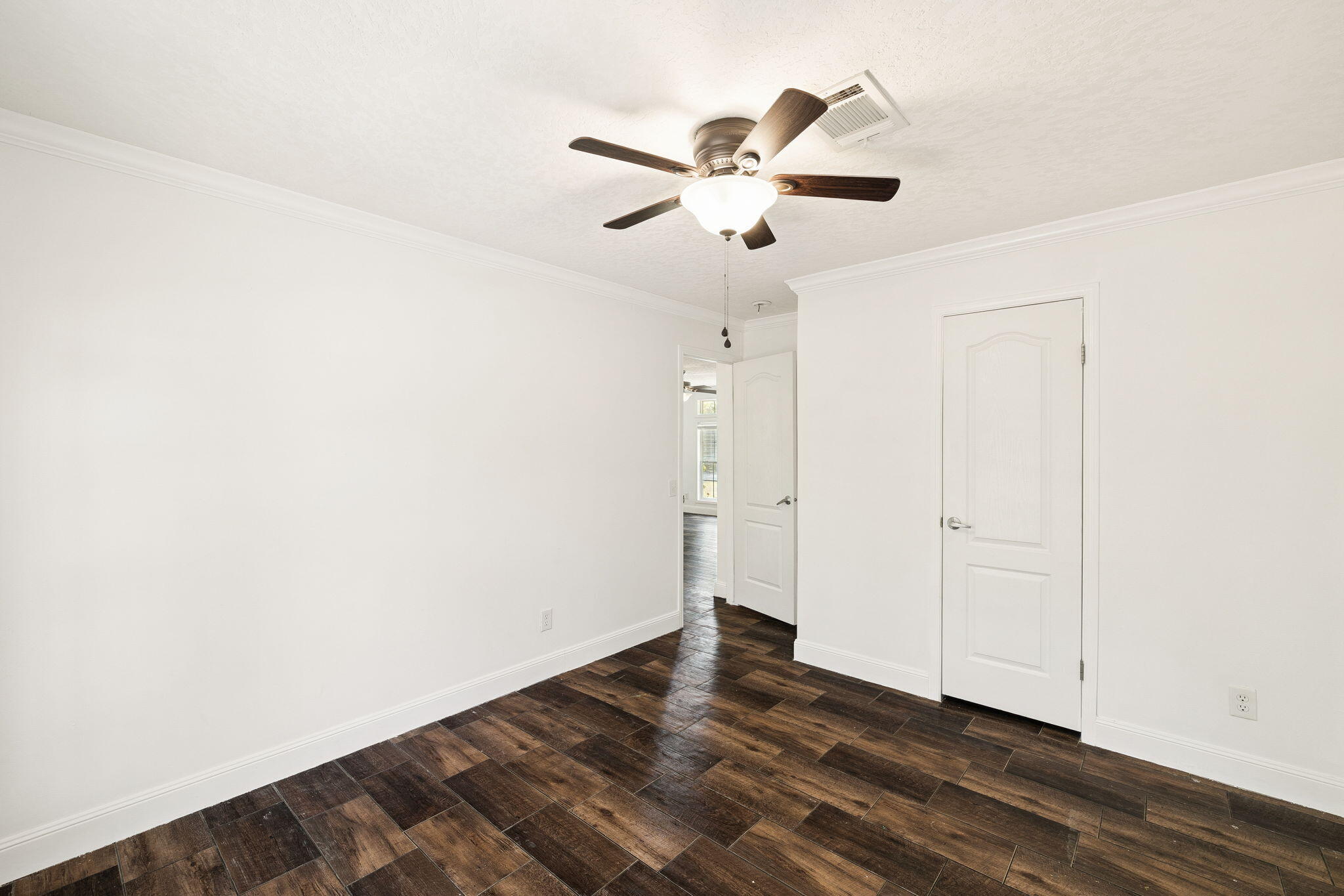 748 Phillips Drive Freeport, FL 32439 - Photo 25 of 32 a view of a room with wooden floor and white walls