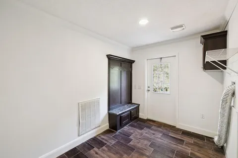 a view of entryway with wooden floor and fence