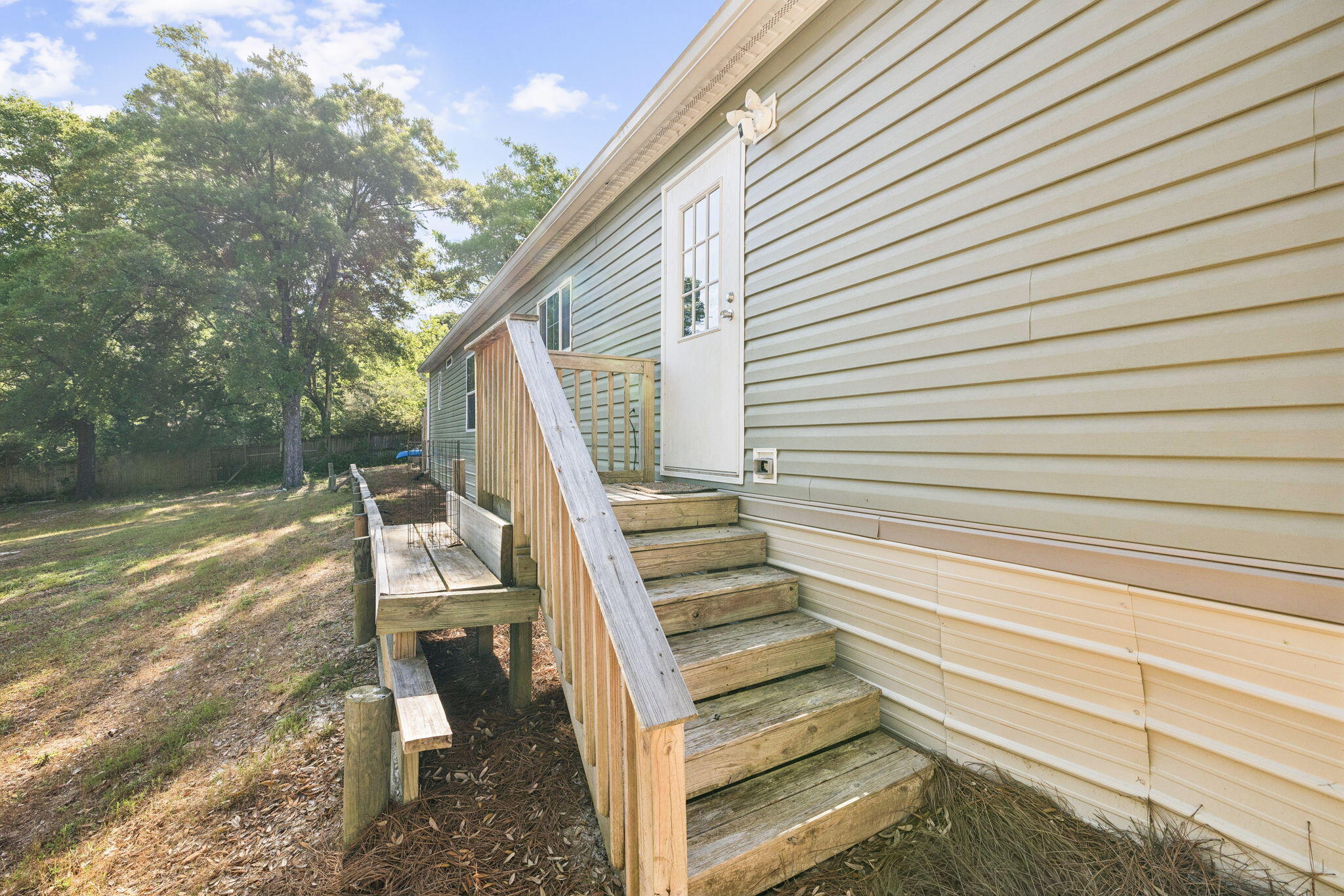 748 Phillips Drive Freeport, FL 32439 - Photo 27 of 32 a view of entryway with wooden floor and fence