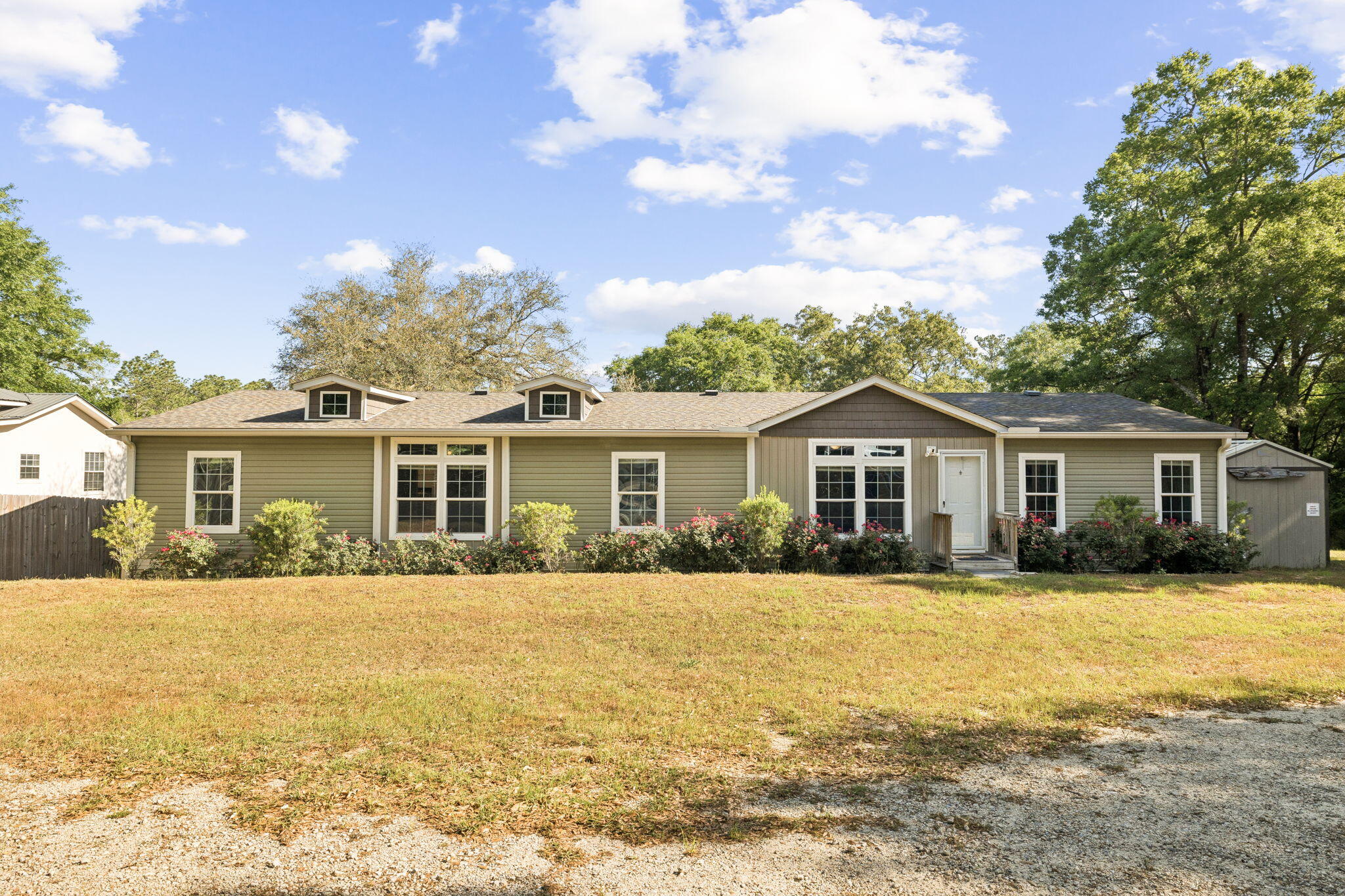 748 Phillips Drive Freeport, FL 32439 - Photo 4 of 32 a front view of a house with a yard