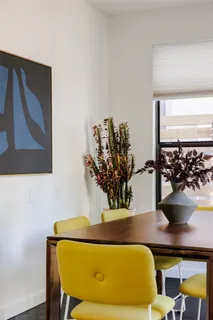 a living room with a couch and a potted plant