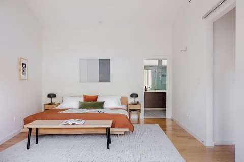 a bedroom with a bed and window