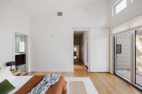 a bedroom with a bed and a mirror