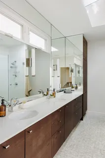 a bathroom with a sink double vanity and a mirror