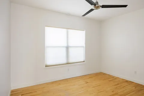 a view of a glass door with wooden floor
