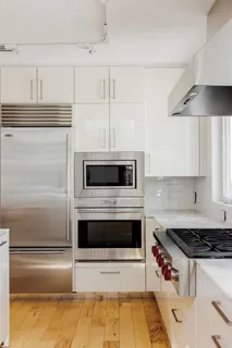 a kitchen with granite countertop stainless steel appliances and counter space