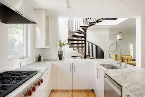a kitchen with a stove a sink and a refrigerator