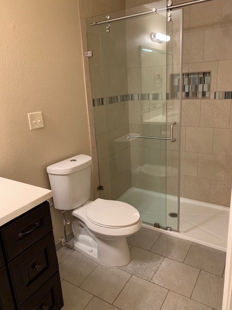 407 West Semands Street Conroe, TX 77301 - Photo 18 of 28 a bathroom with a toilet and a shower