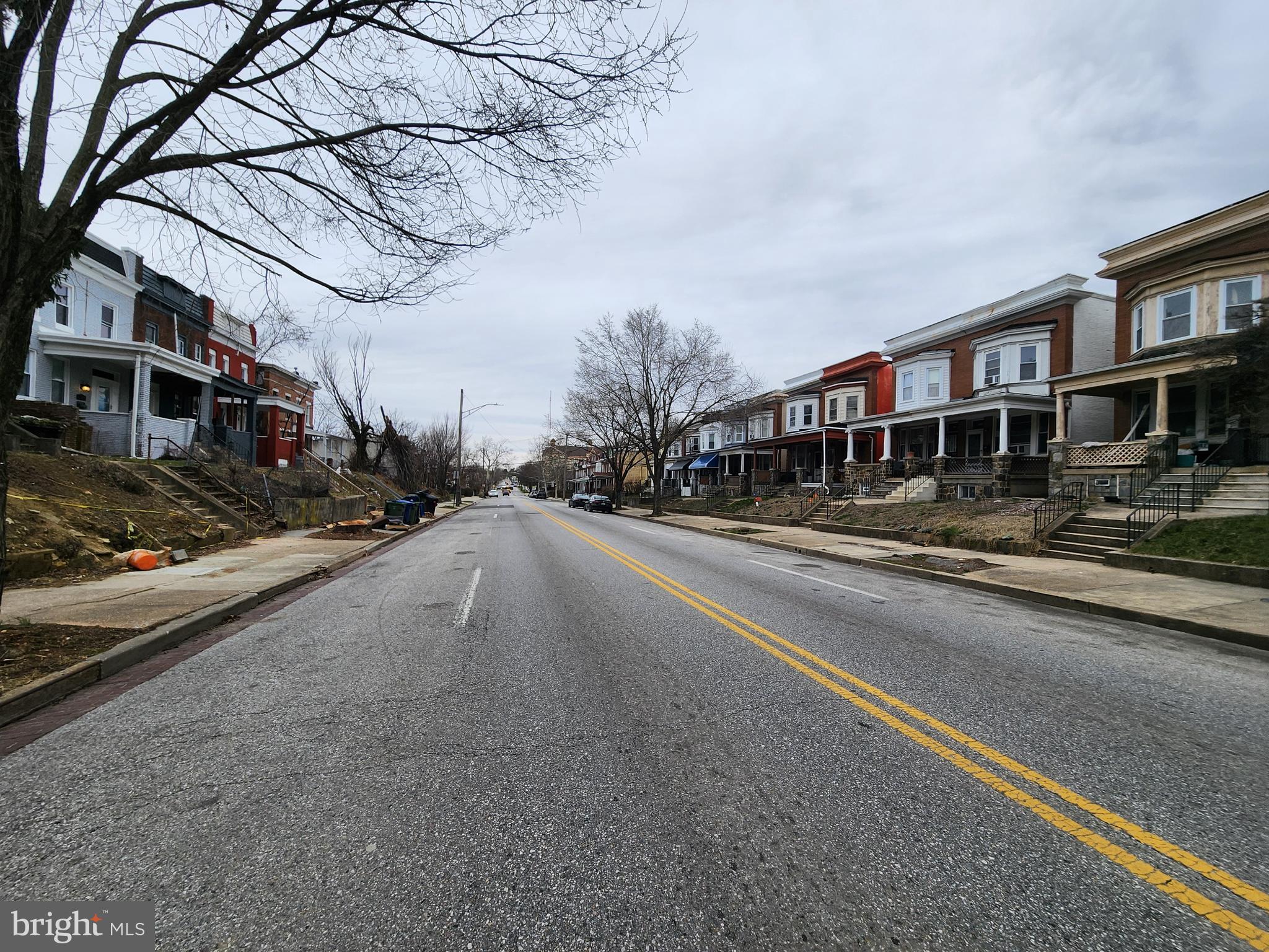 3714 Reisterstown Road Baltimore, MD 21215 - Photo 3 of 4 a city street lined with buildings and trees