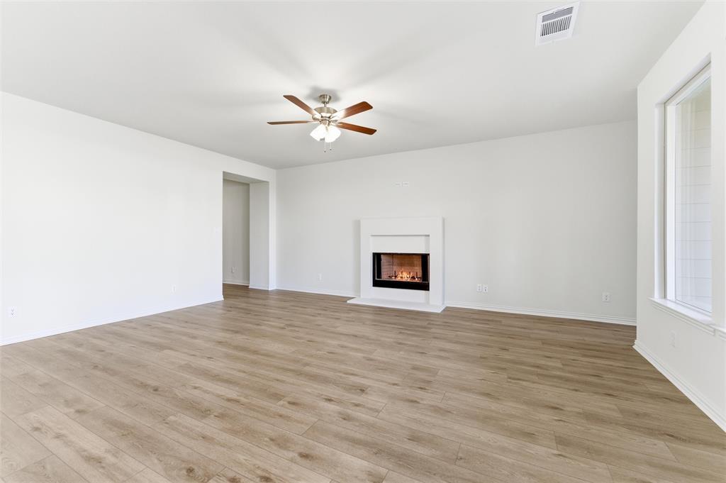 3513 Helena Street Gainesville, TX 76240 - Photo 13 of 25 a view of an empty room with a window and wooden floor