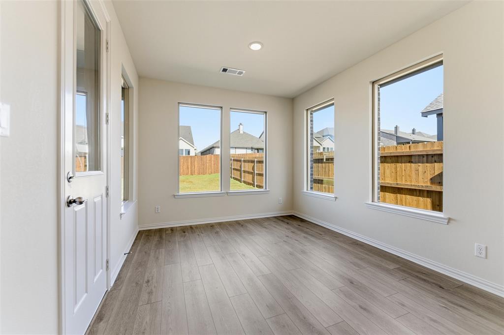3513 Helena Street Gainesville, TX 76240 - Photo 14 of 25 an empty room with wooden floor and windows