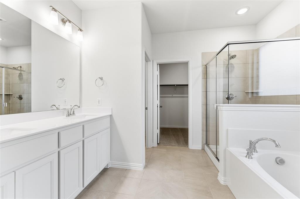 3513 Helena Street Gainesville, TX 76240 - Photo 16 of 25 a bathroom with a double vanity sink mirror and shower