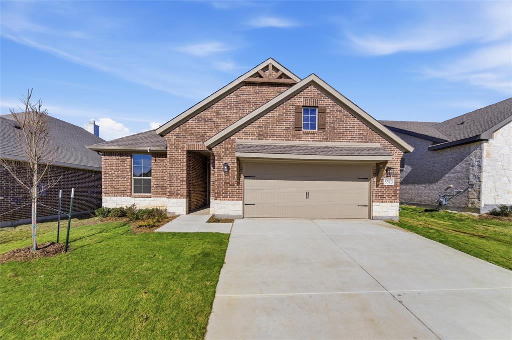3513 Helena Street Gainesville, TX 76240 - Photo 24 of 25 a front view of a house with a yard and garage