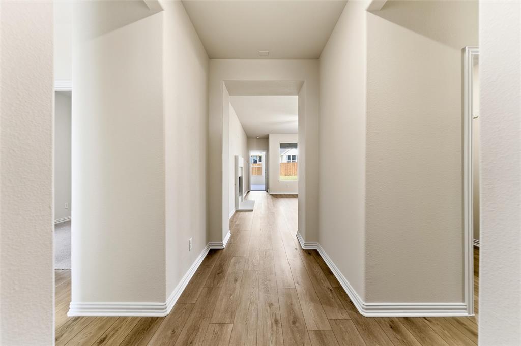 3513 Helena Street Gainesville, TX 76240 - Photo 3 of 25 a view of a hallway with wooden floor