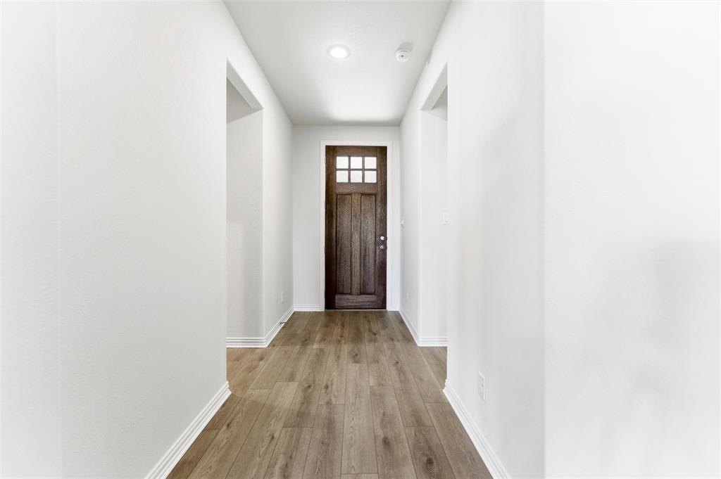 3513 Helena Street Gainesville, TX 76240 - Photo 4 of 25 a view of a hallway with wooden floor