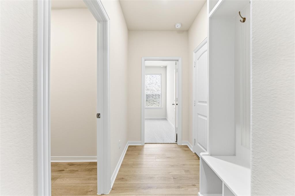 3513 Helena Street Gainesville, TX 76240 - Photo 9 of 25 a view of a hallway with wooden floor