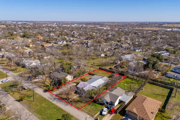 a view of a backyard with a large tree