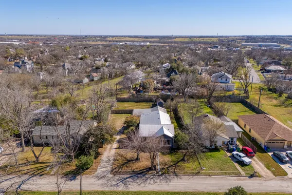 an aerial view of residential houses with outdoor space