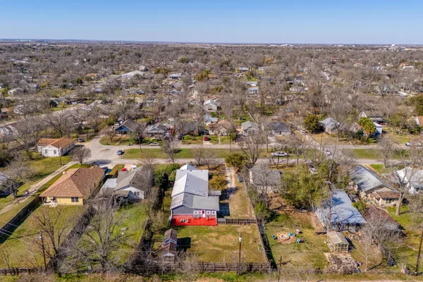 an aerial view of residential houses with outdoor space