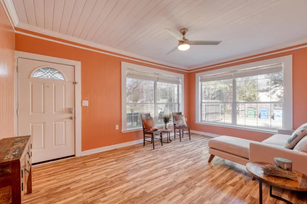 a living room with furniture and a wooden floor